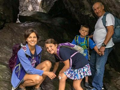 Family poses in a cave