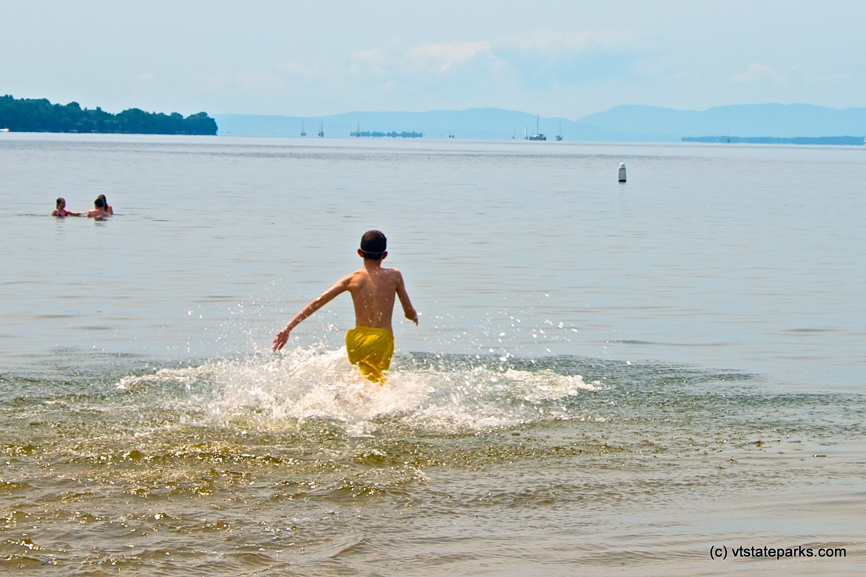 Running into the water at Alburgh Dunes State Park by Amy Chess