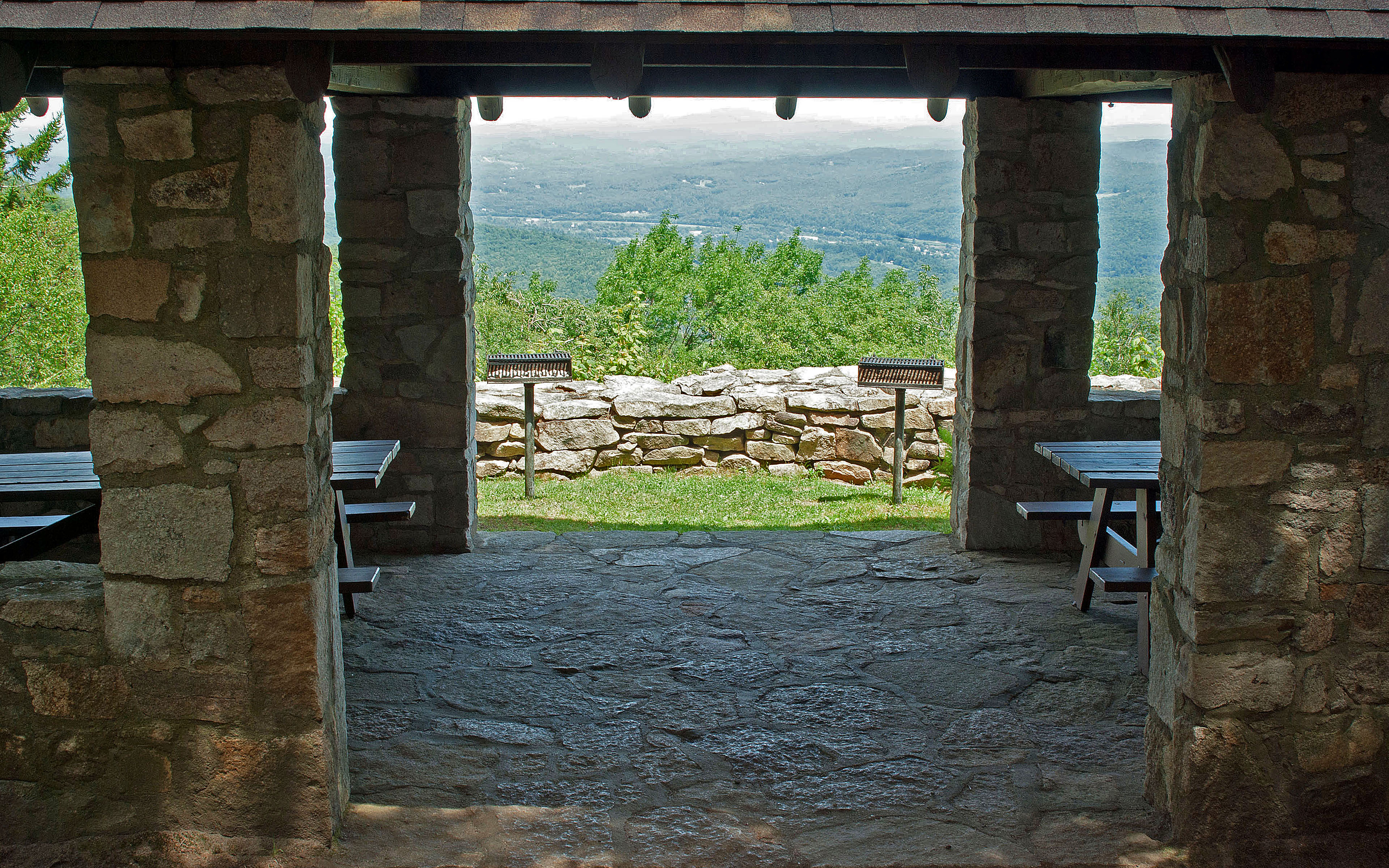 Inside the stone and wood picnic pavilion at Mt. Ascutney State Park by Paul Anderson