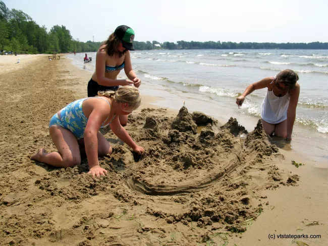 Girls building sand castles at Alburg Dunes State Park by Raven Schwan-Noble