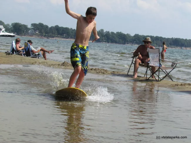 Catching a ride with a skimboard at Alburg Dunes State Park by Raven Schwan-Noble