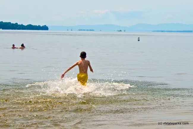 Running into the water at Alburgh Dunes State Park by Amy Chess