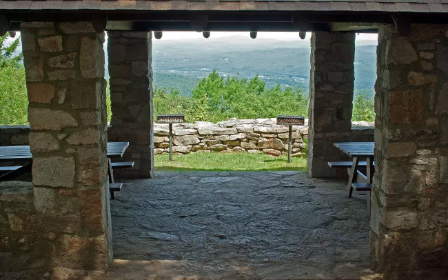 Inside the stone and wood picnic pavilion at Mt. Ascutney State Park by Paul Anderson