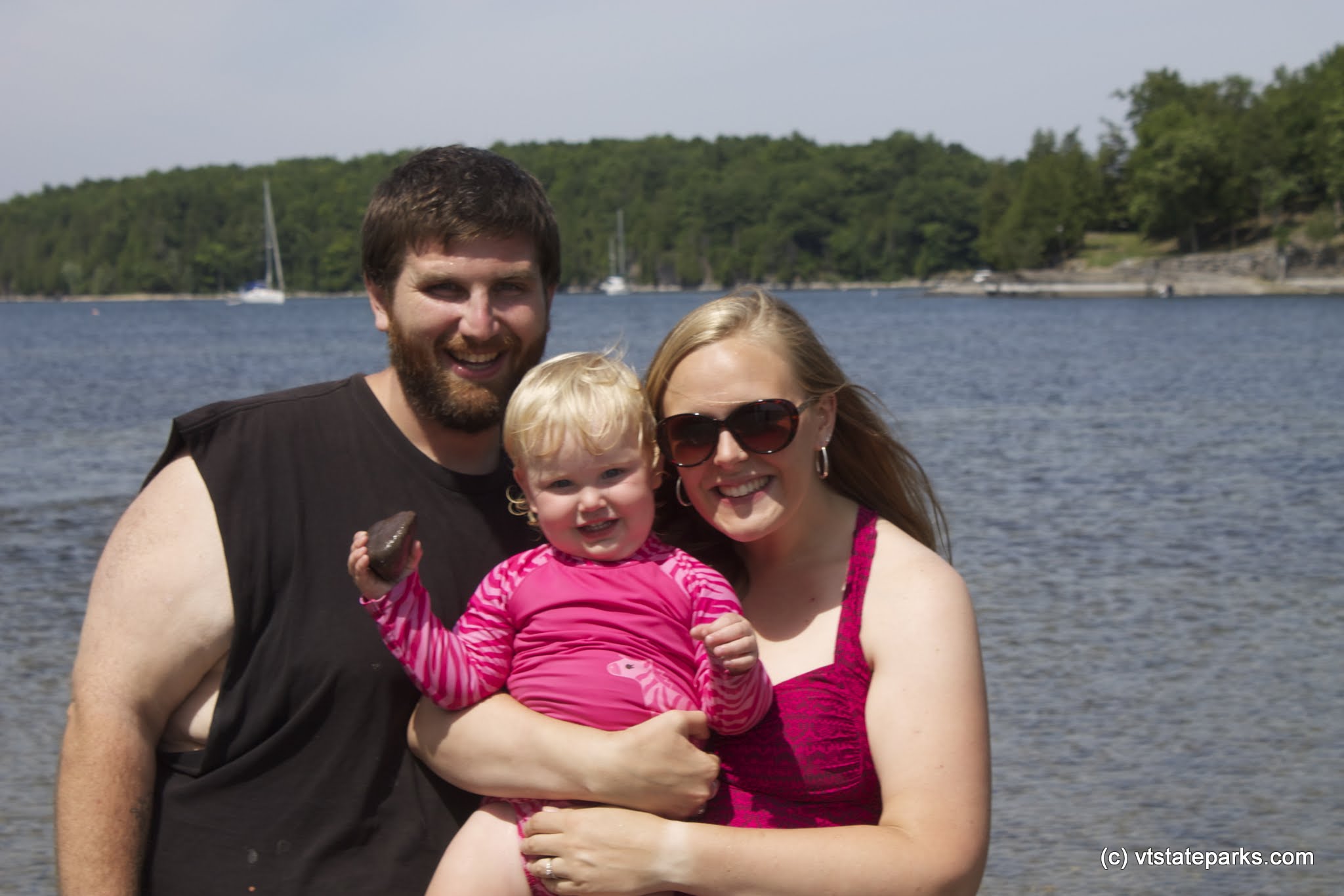 Happy family poses at Niquette Bay State Park by Alexa Collesides