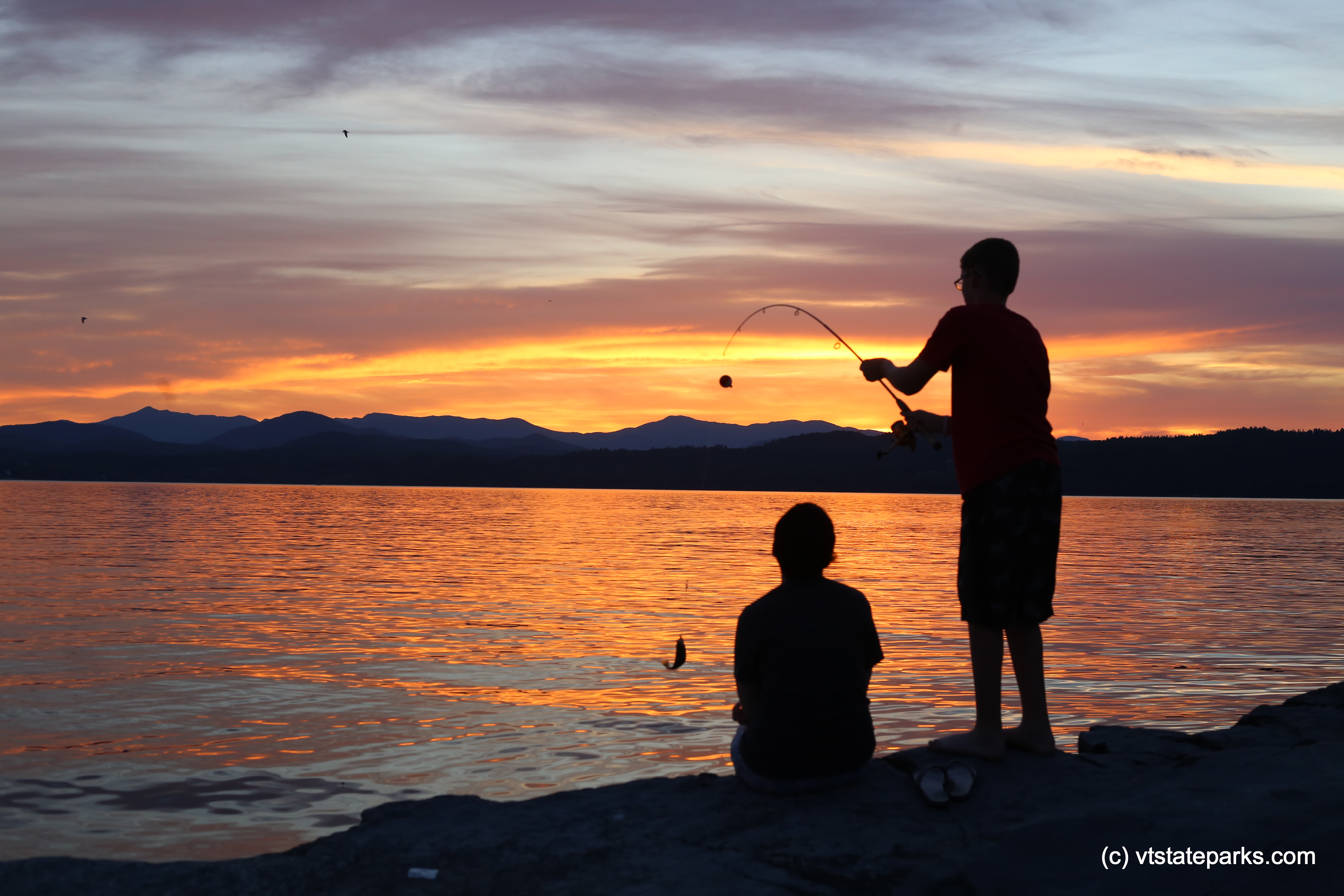 Boys fishing during a beautiful sunset at Button Bay State Park by Amanda Vincent