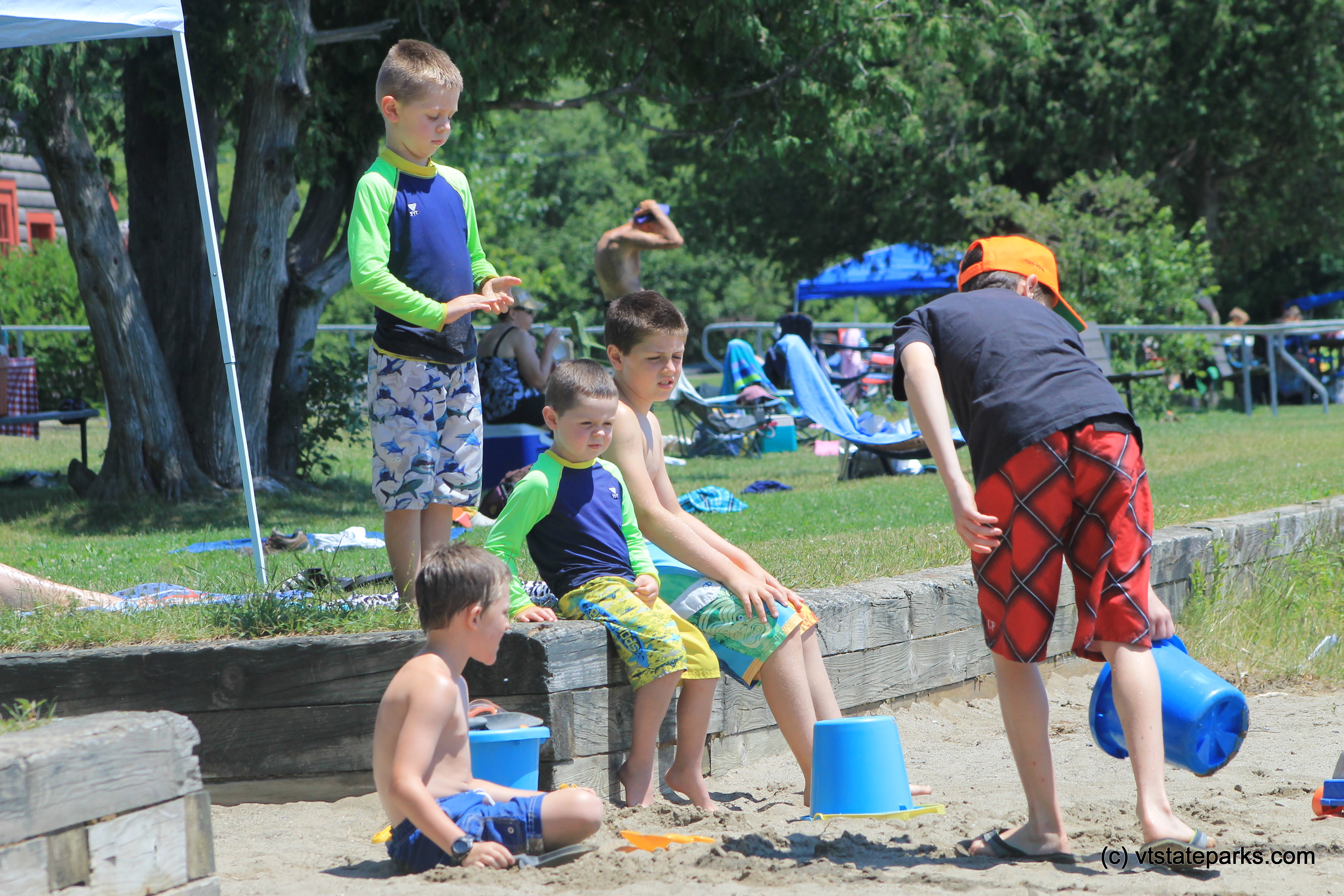 Group of cool guys playing in the sand at Elmore State Park by Joanne Pereira