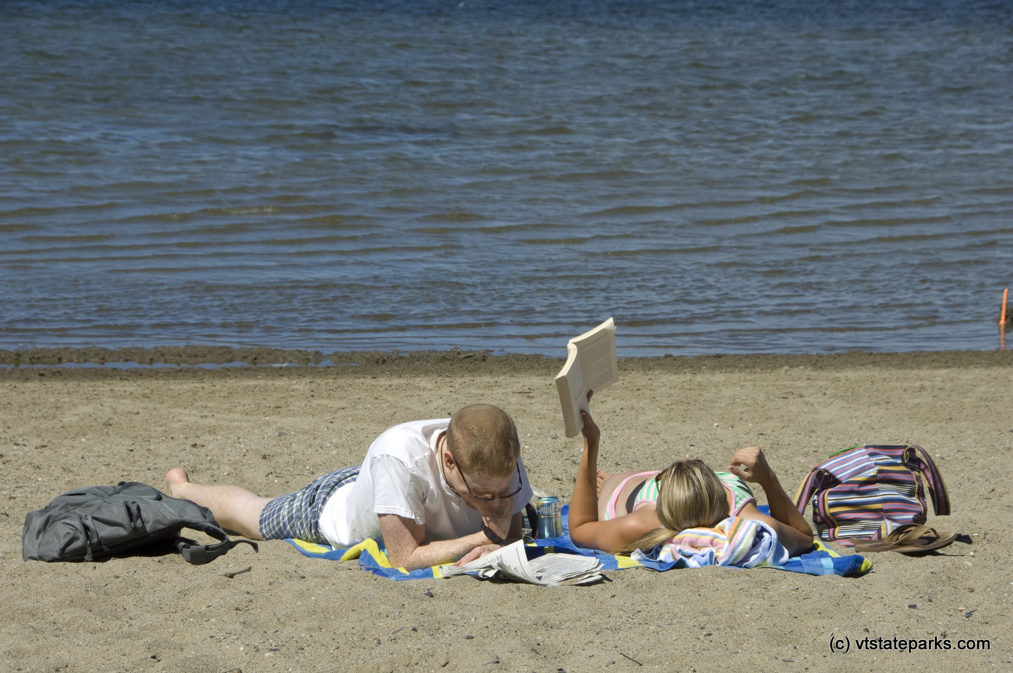 Matthew MacNeil and Martha Dalryniple catch up some reading at Sand Bar State Park. They were visiting from Virginia.  Photo by Karen Pike