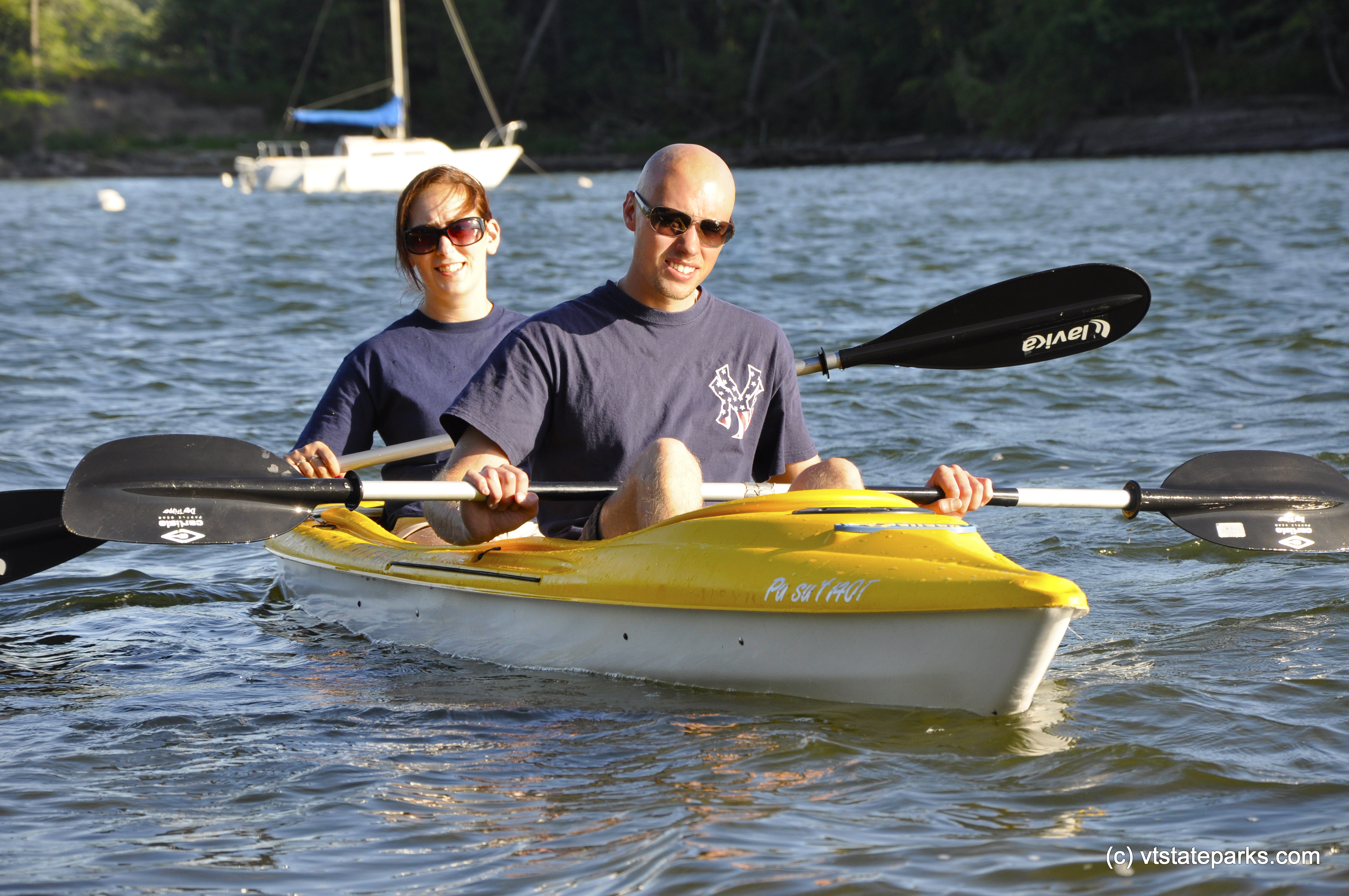 Kayaking with sailboat in the background at Kingsland Bay State Park by Julia Parent