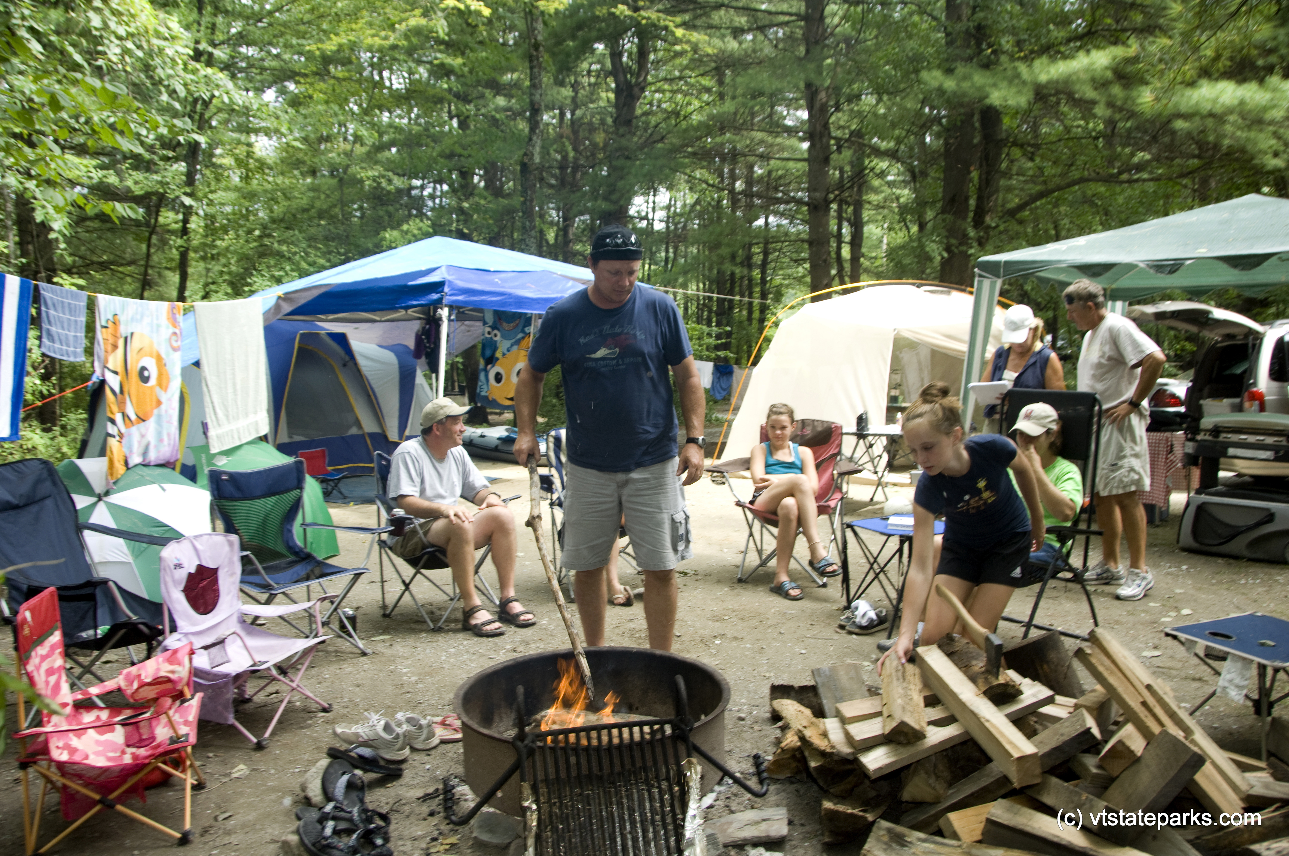 Kevin Higgins of South Glens Falls, NY, acts as the firemaster at the multi family campsite at Bomozeen State Park. Photo by Karen Pike