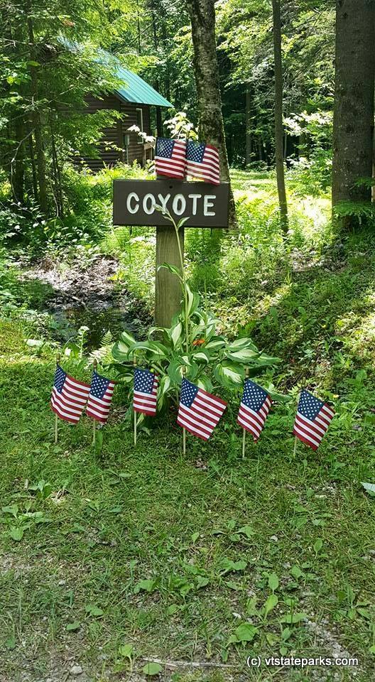 Cabin Coyote at Gifford Woods State Park sign decorated for 4th of July
