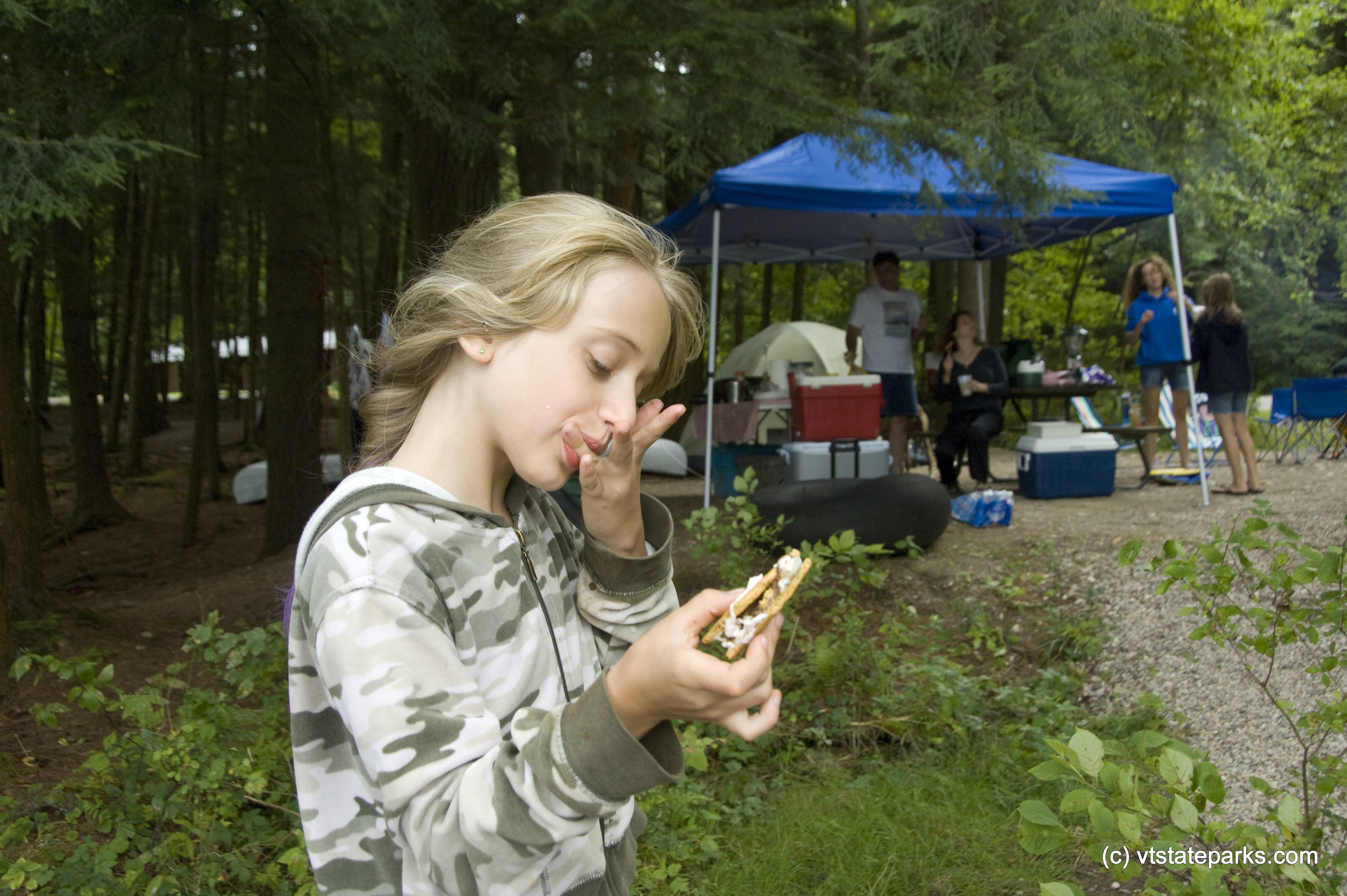 Jacklyn Carrara enjoys a smore while camping with her family at Half Moon Pond State Park. Photo by Karen Pike