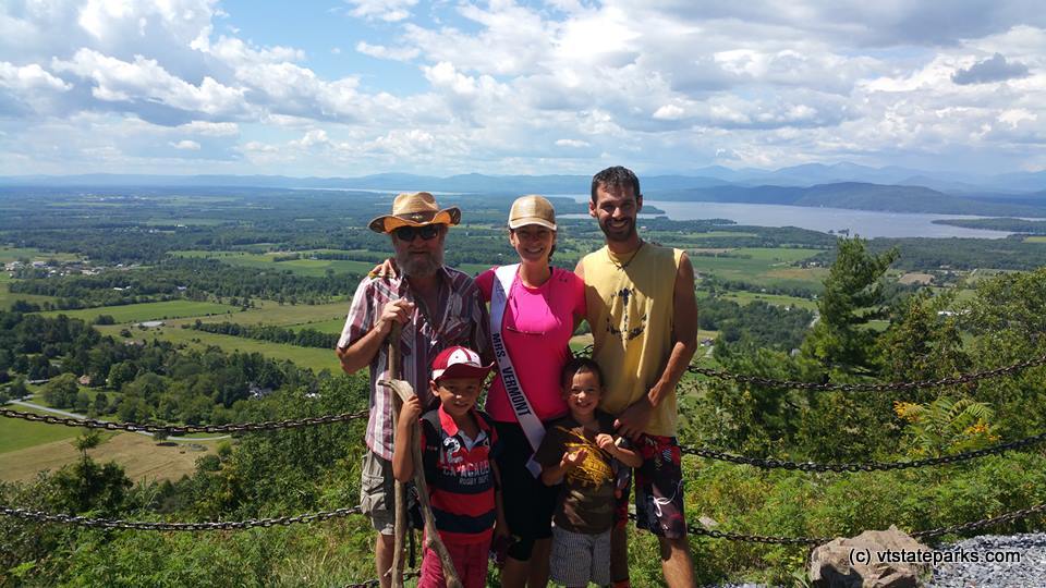 Mrs. Vermont poses with a family on top of Mt. Philo State Park.