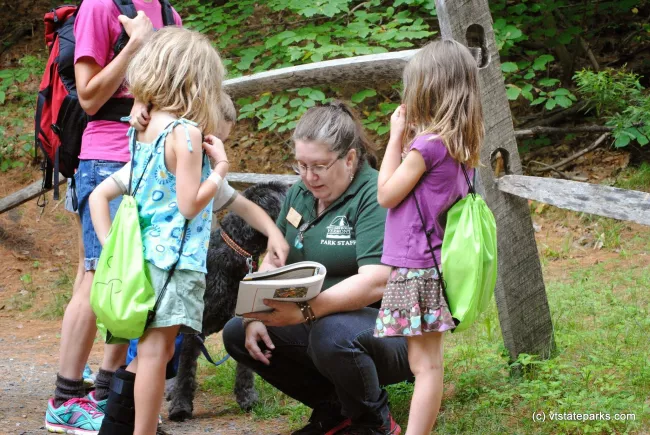 Ranger Lisa going through guide book with kids at Quechee State Park by Nicole Olmstead