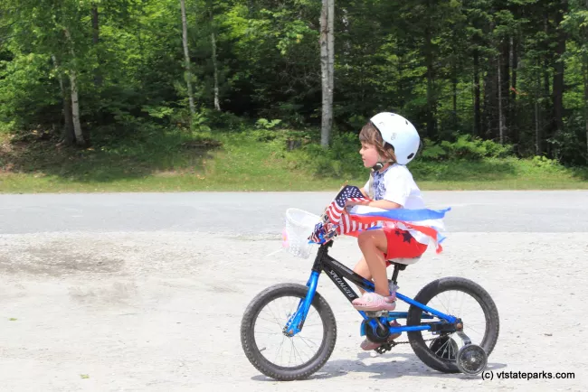 Tiny rider in the 4th of July bike parade at Stillwater State Park by David Jalbert