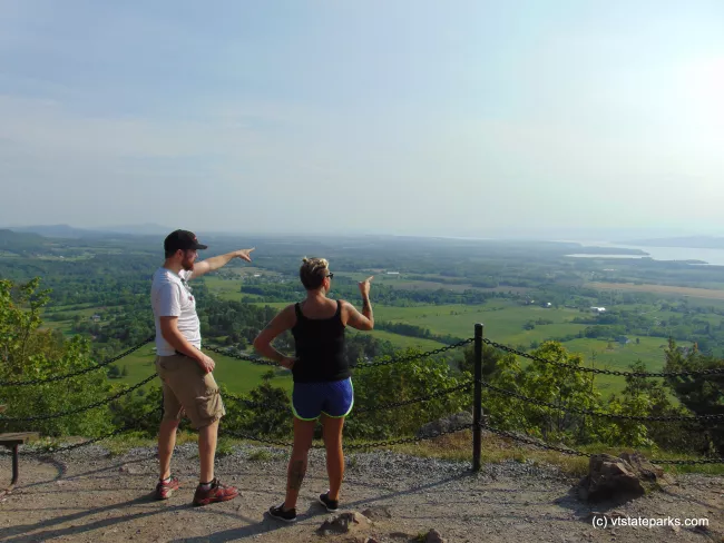 Pointing into the distance from Mt. Philo State Park summit by Belinda Lafountain