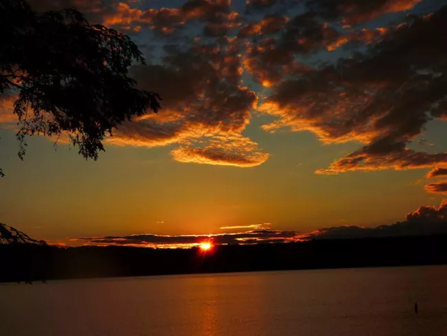 A sunset lights up the sky at Lake Carmi State Park, by Marlene Handler.