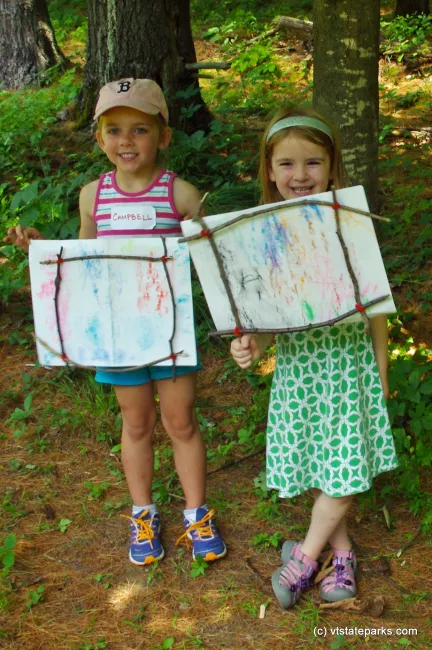 Smiling kids with their crafts at Niquette Bay State Park by Jessica Clark