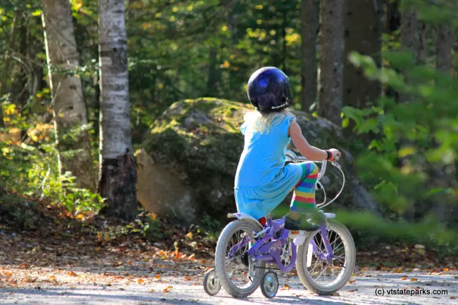Girl enjoying a bike ride at Ricker Pond State Park by Lene Gary