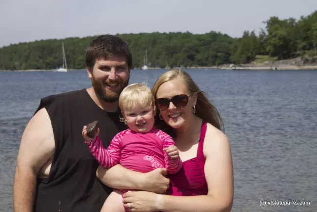 Happy family poses at Niquette Bay State Park by Alexa Collesides