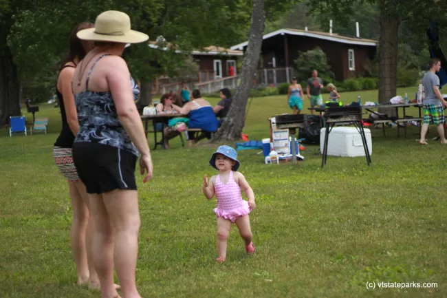 Little girl smiling at the beach at Camp Plymouth State Park by Cara Goodenough
