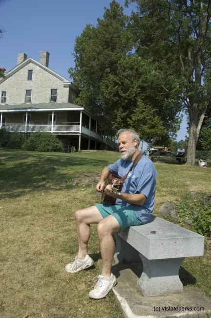 Joe Manley or Brooklyn, NY relaxes with his guitar while visiting Kingland Bay State Park. Photo by Karen Pike