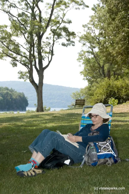 Michele Volino of NYC, enoys some quiet reading at Kingsland Bay State Park. Photo by Karen Pike