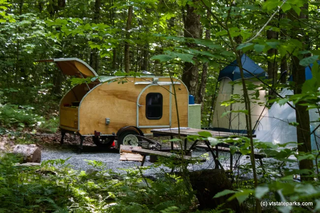Very cozy camper with an outdoor shower in Molly Stark State Park by Tara Schatz