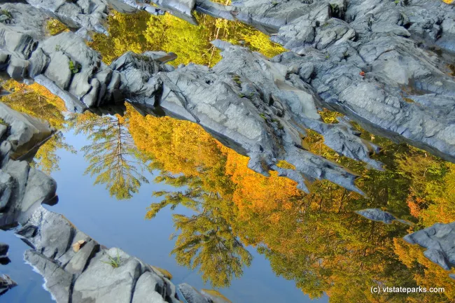 Stunning reflection of the ledges in the Quechee gorge at Quechee State Park by Tara Schatz