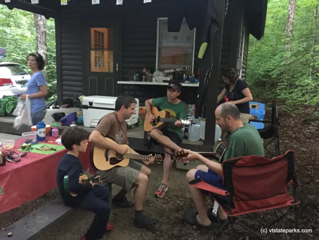 Some people gathering at Ricker Pond State Park to play some music