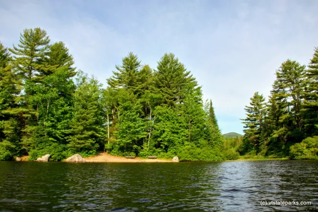 View from water of the beach at Ricker Pond State Park