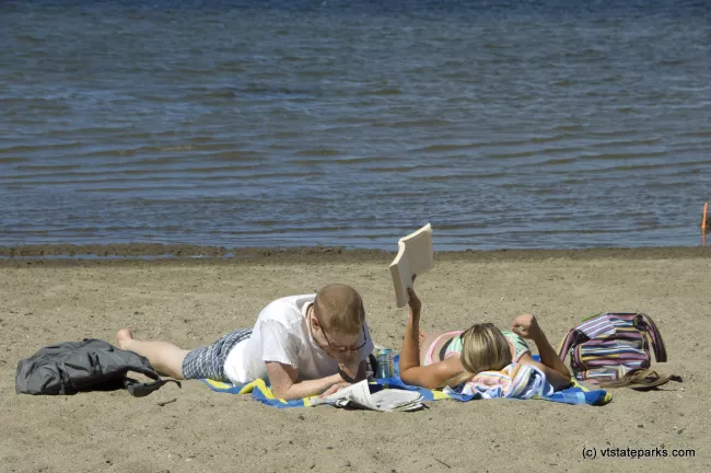 Matthew MacNeil and Martha Dalryniple catch up some reading at Sand Bar State Park. They were visiting from Virginia.  Photo by Karen Pike