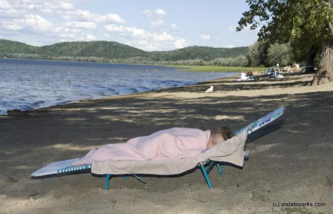 Three-year-old Shea Howrigan of St. Albans, Vermont, naps after a long day at Sand Bar State Park.  Photo by Karen Pike