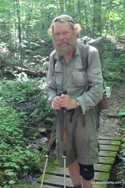 Thru-Hiker hiking the Appalachian Trail in Gifford Woods State Park by Isadora Marks