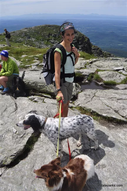 Hiker with dogs at the summit, Underhill State Park