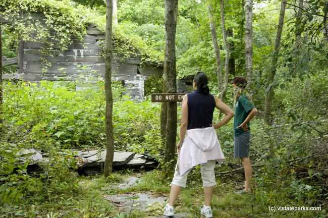 Bomozeen State Park employee Keely Flynn, right,  leads a tour of the Slate History trail at Bomozeen State Park The 3/4 mile trail leads explorers through the remains of the West Castleton Railroad and Slate Company. Photo by Karen Pike