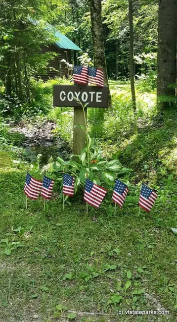 Cabin Coyote at Gifford Woods State Park sign decorated for 4th of July