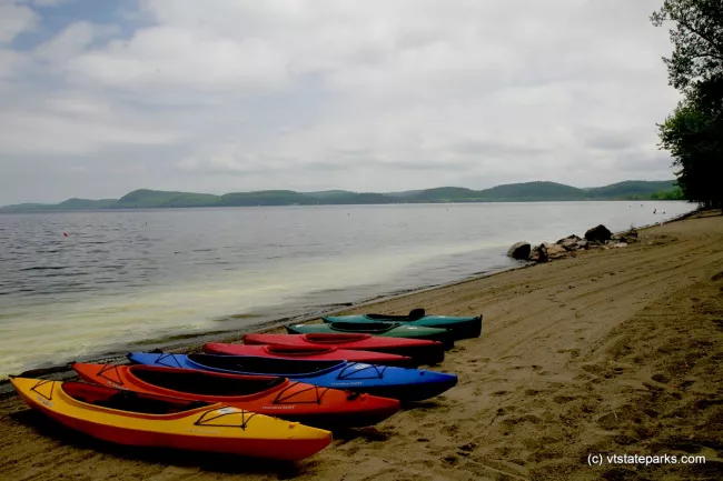 Rainbow of kayaks at Sand Bar State Park by Al Abrams