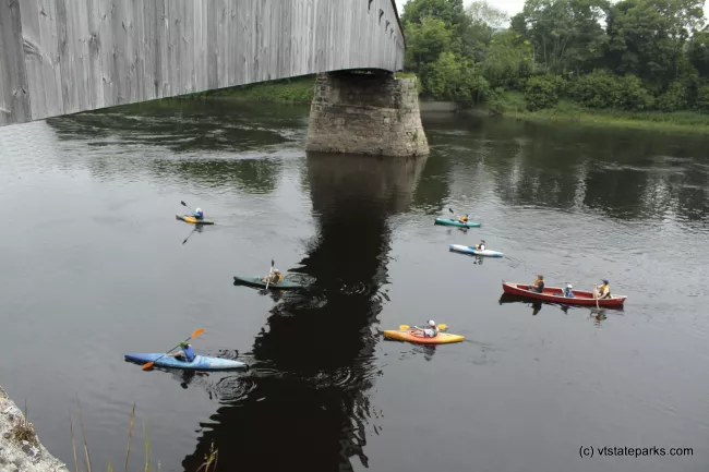 Paddlers cross beneath the Cornish Windsor Bridge at Wigus State Park by Shari McBride