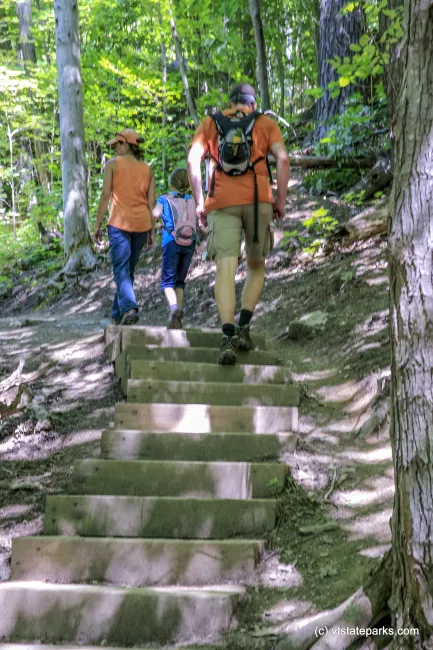 Family hiking up steps on a trail in Mt Philo State Park by Bob Ricketson