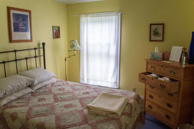 A bedroom at the lodge offers creature comforts and rustic tranquility.
