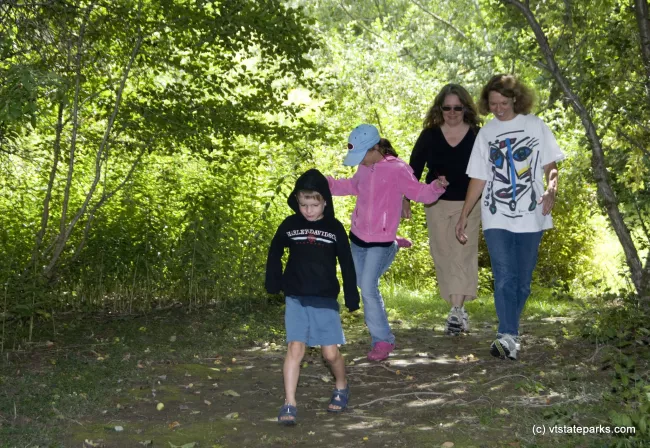 Kitty Goldberg, her children Scott and Zeph Watkins and Ronda Anderson of New York walk the trails at Waterbury Ctr State Park. Photo by Karen Pike